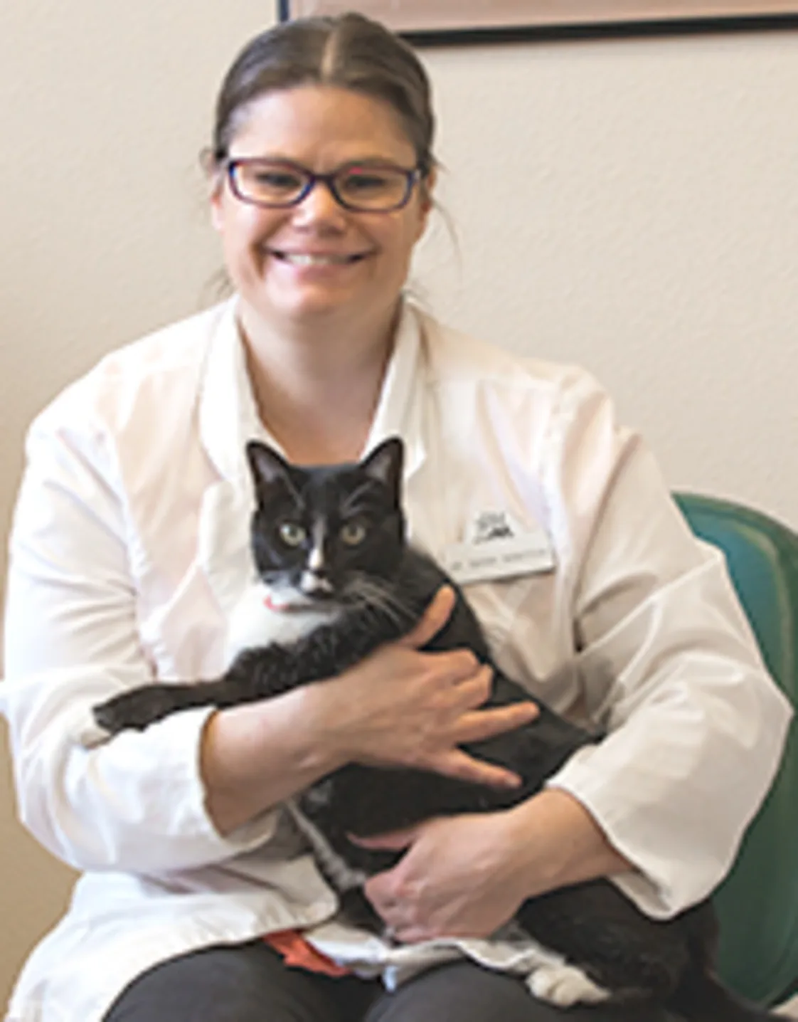 Dr. Sarah Bangtson sitting while holding cat Dr. Sarah Bangtson sitting while holding cat
