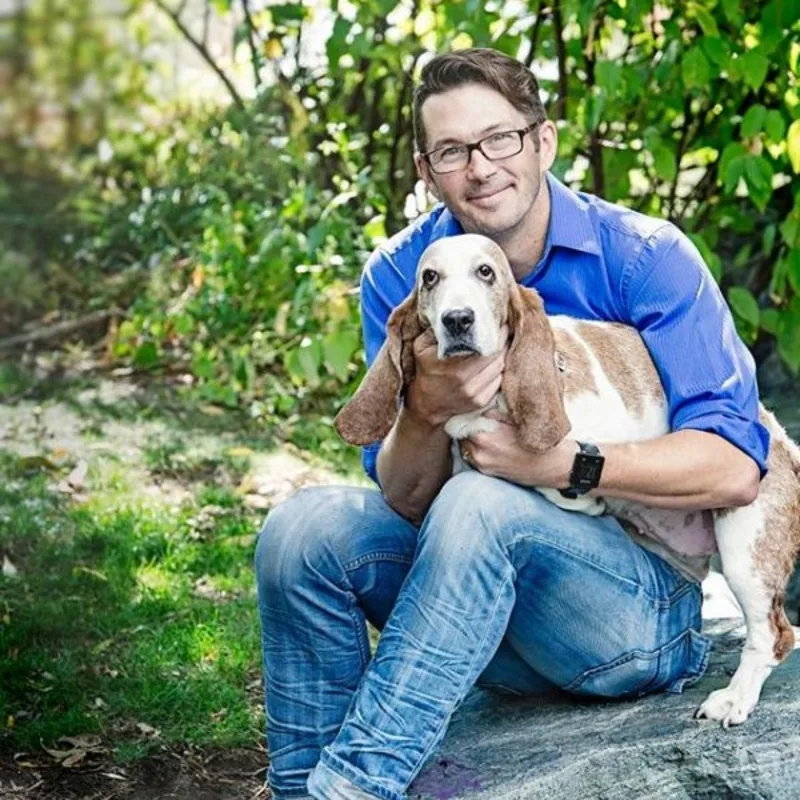 Dr. Stephen Ganton holding onto a long eared dog. Dr. Stephen Ganton holding onto a long eared dog.