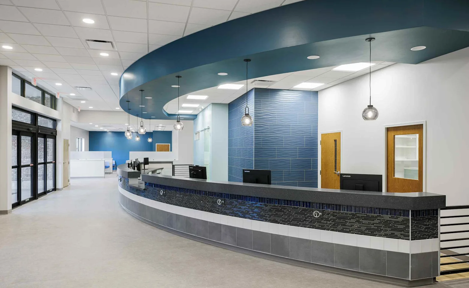 Blue and gray circle reception desk against a white wall. Blue and gray circle reception desk against a white wall.