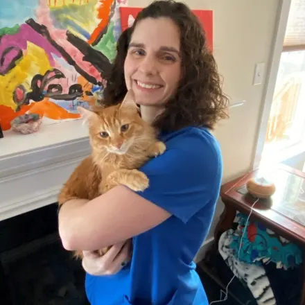 Dr. Erica D. Kellar-Brown holding a yellow tabby cat.