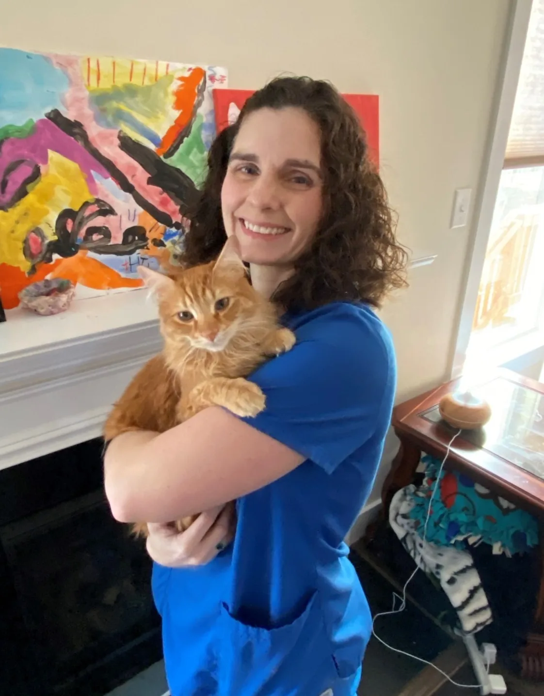 Dr. Erica D. Kellar-Brown holding a yellow tabby cat. Dr. Erica D. Kellar-Brown holding a yellow tabby cat.