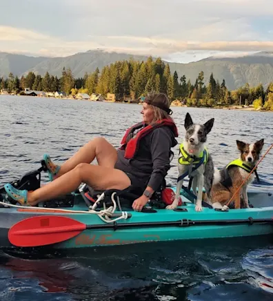 Crystal on a paddleboard with two dogs Crystal on a paddleboard with two dogs