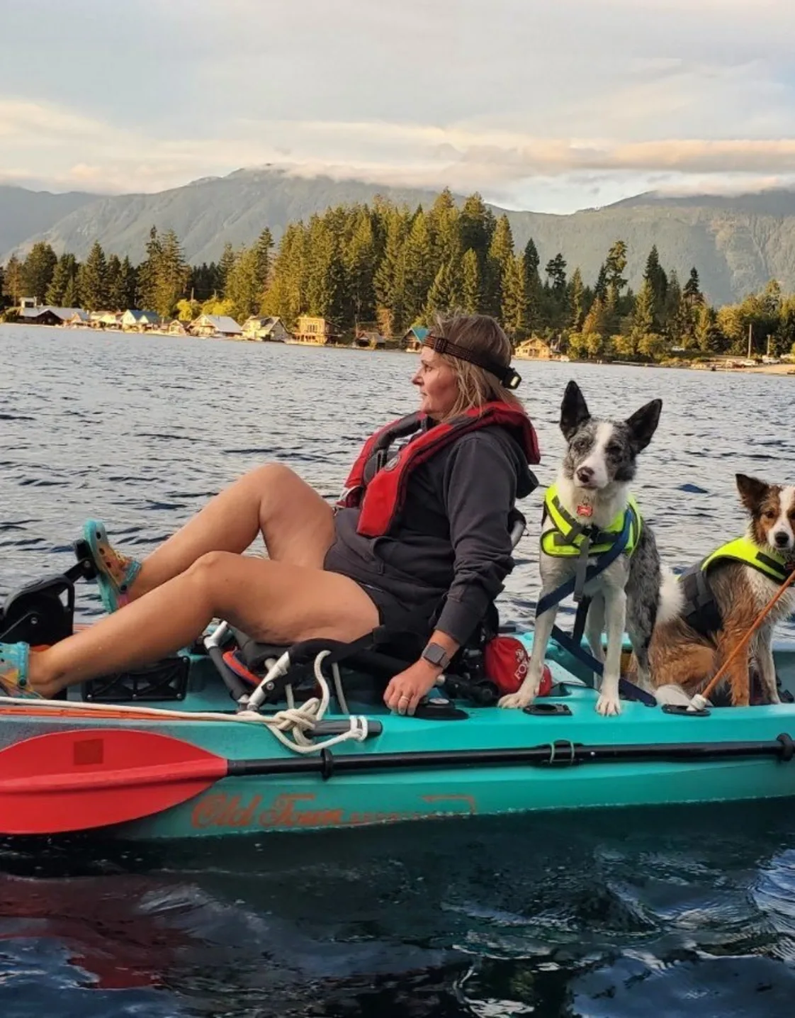 Crystal on a paddleboard with two dogs Crystal on a paddleboard with two dogs