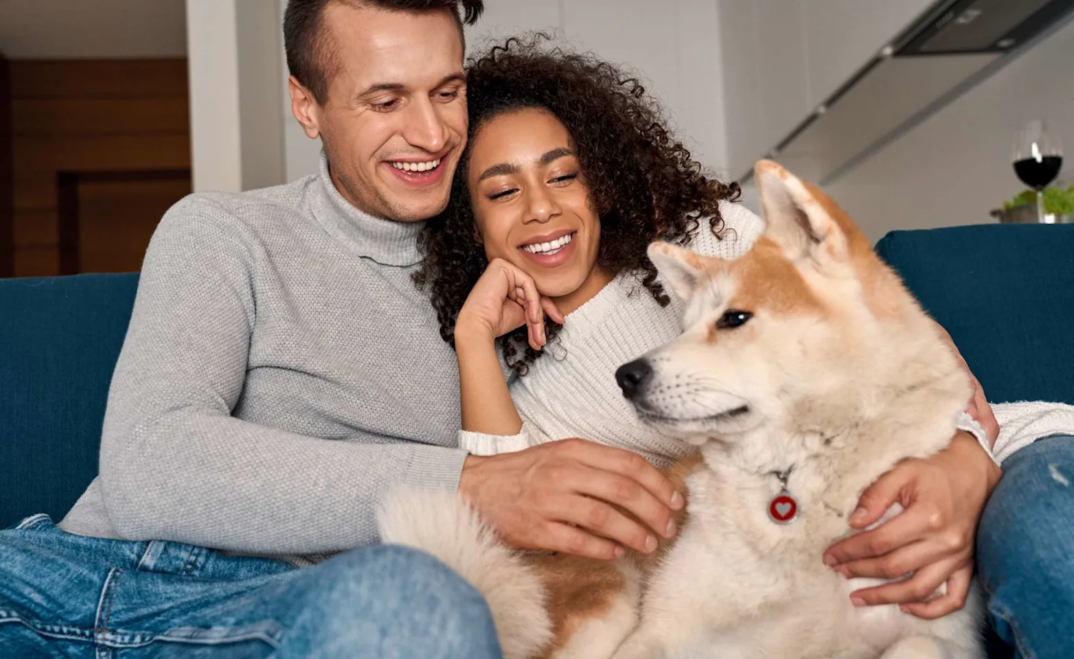 Couple on couch with dog at home Couple on couch with dog at home
