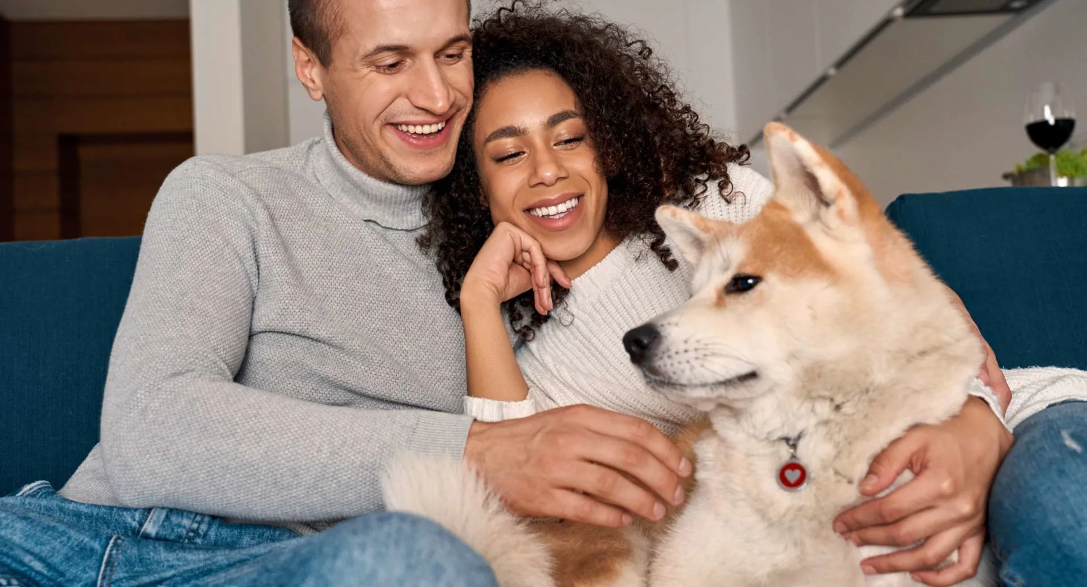 Couple on couch with dog at home Couple on couch with dog at home