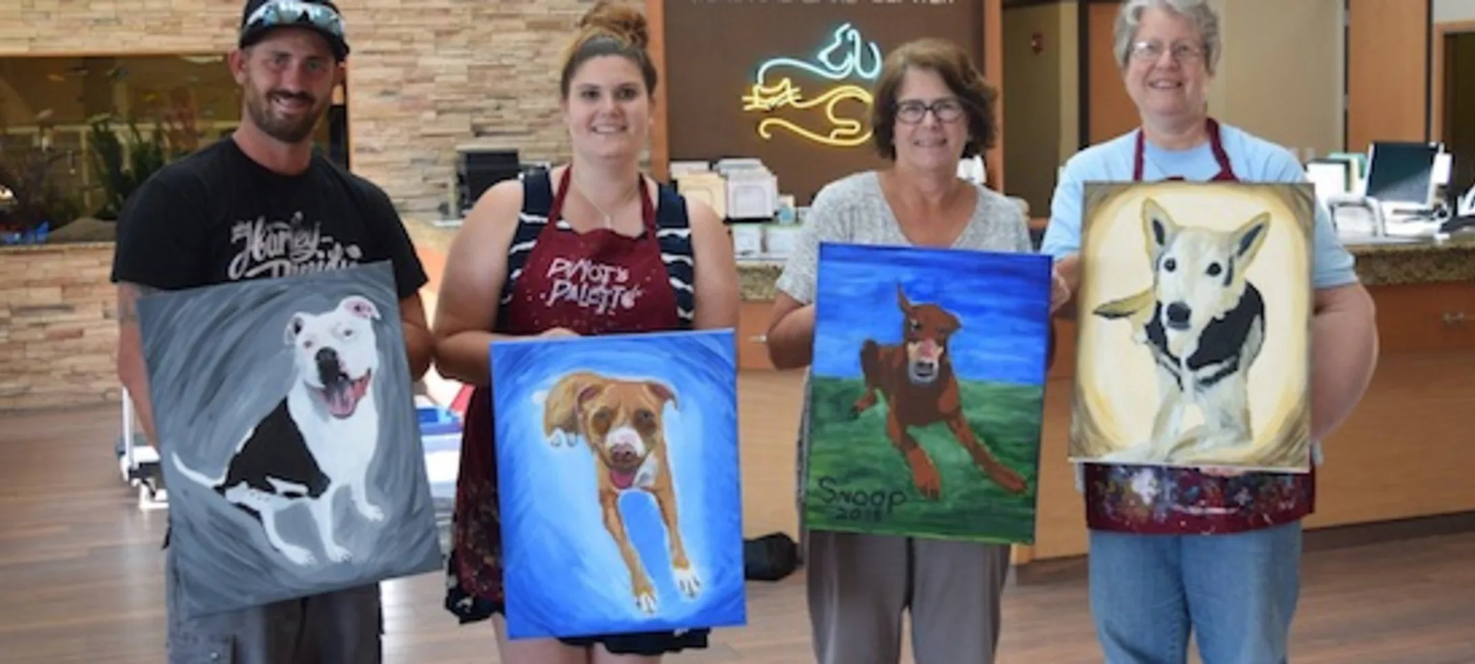 staff showing off paintings