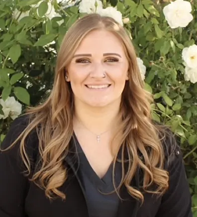 Woman wearing black jacket smiling at camera Woman wearing black jacket smiling at camera
