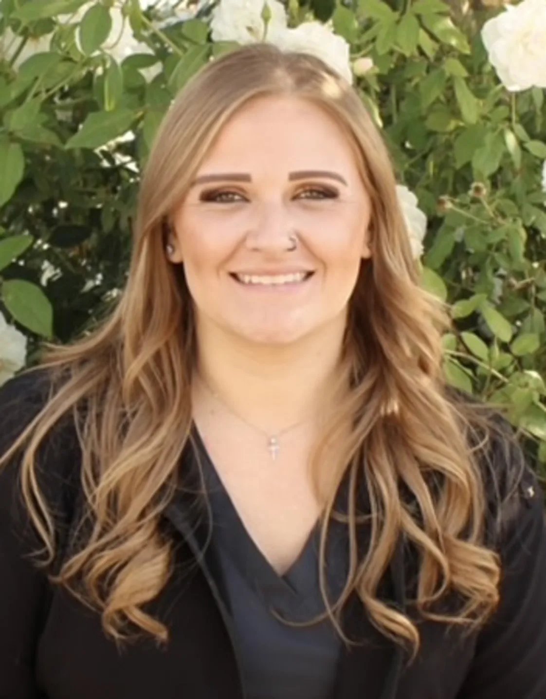 Woman wearing black jacket smiling at camera Woman wearing black jacket smiling at camera