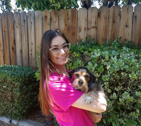Keyleigh holding a groomed dog