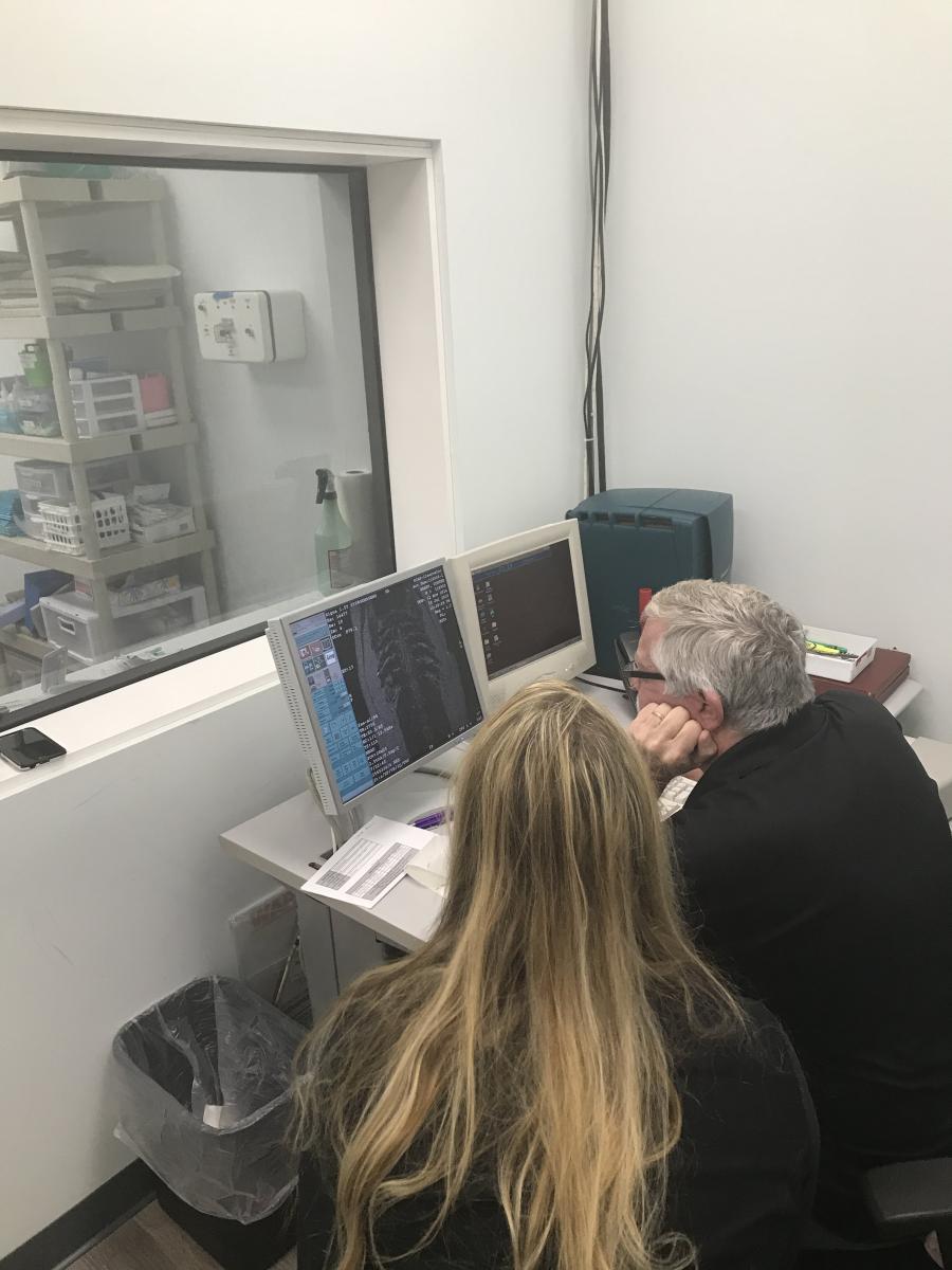 Two SCAN Clearwater veterinary staff examining diagnostic imaging results