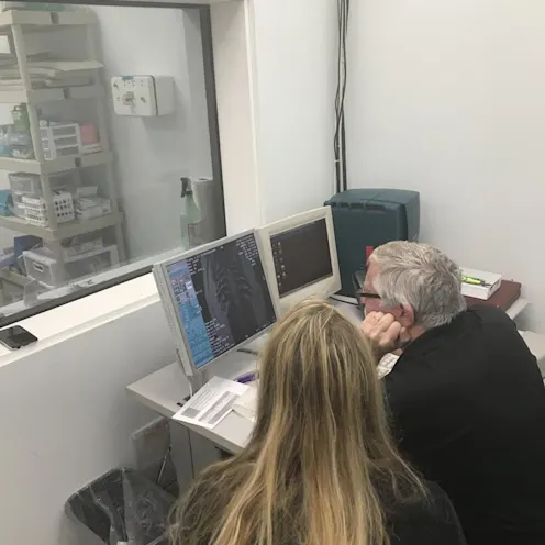 Two SCAN Clearwater veterinary staff examining diagnostic imaging results Two SCAN Clearwater veterinary staff examining diagnostic imaging results