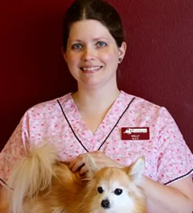 Holly smiling while holding a dog Holly smiling while holding a dog