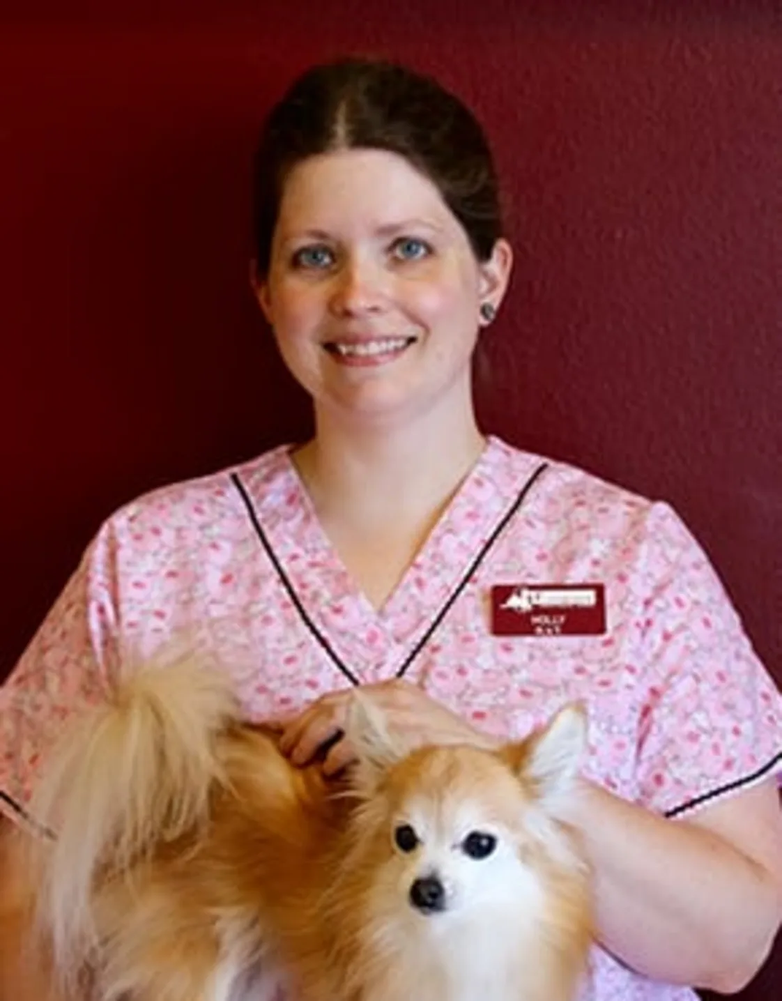 Holly smiling while holding a dog Holly smiling while holding a dog