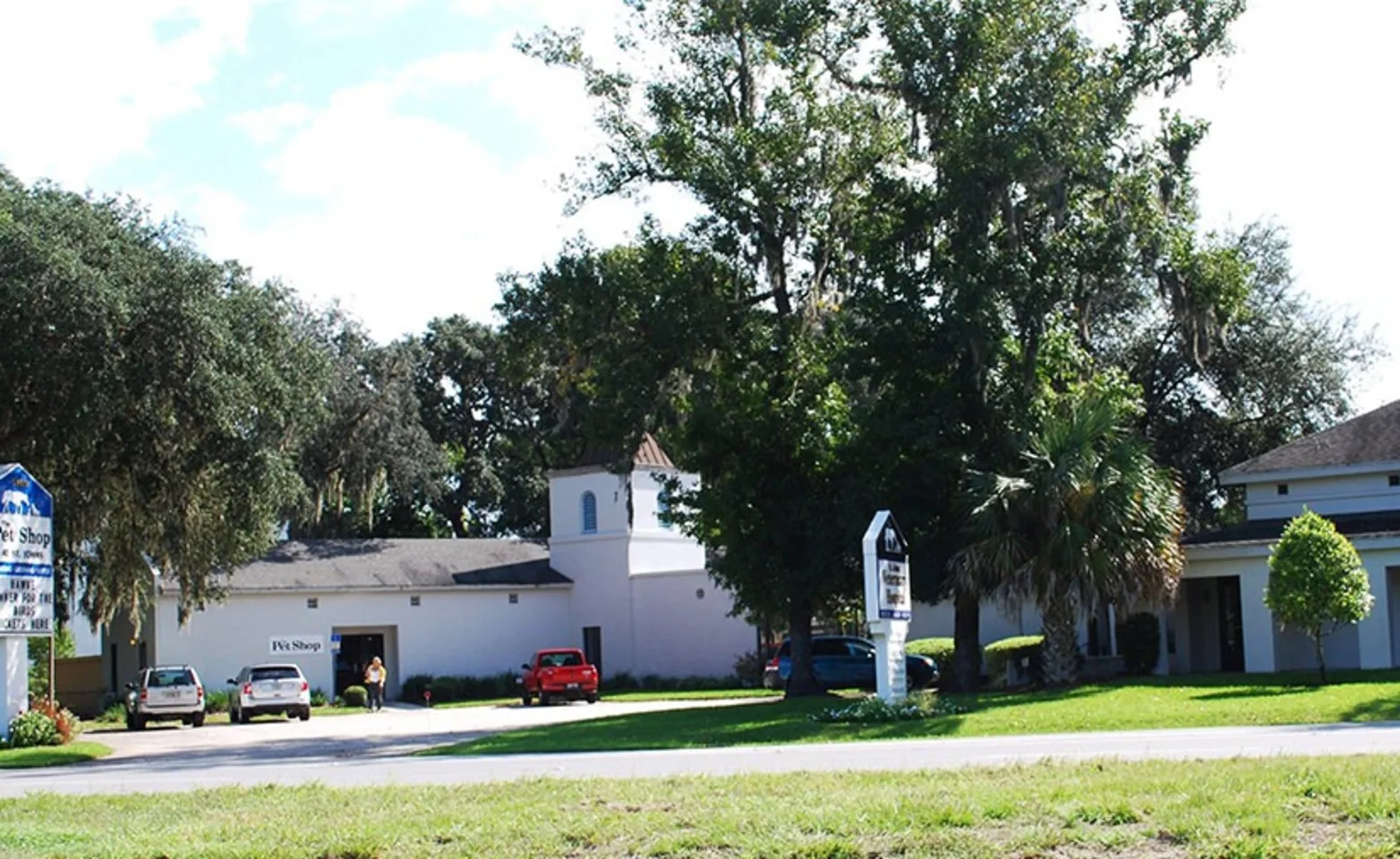 St. Johns Veterinary Hospital exterior with green, grassy lawn and trees.