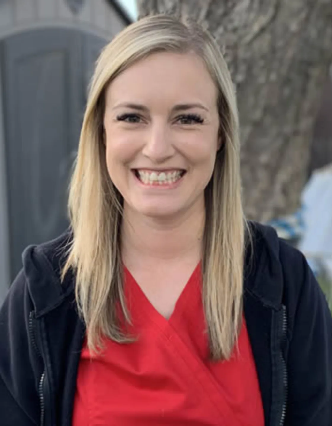 Woman with a red shirt smiling at camera Woman with a red shirt smiling at camera
