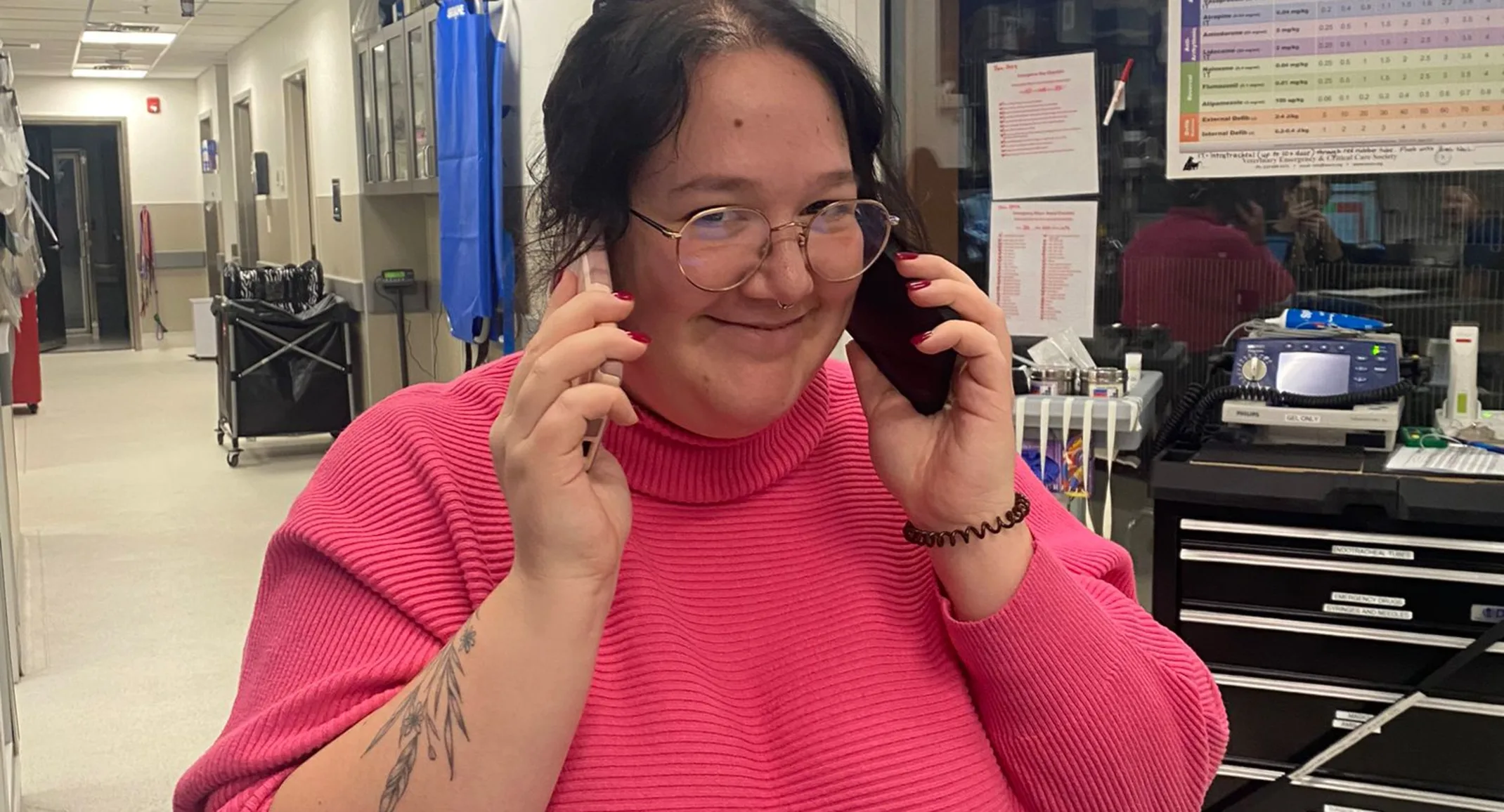 Staff member holding phones Staff member holding phones