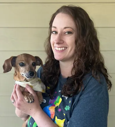 Angie House holding a small brown dog Angie House holding a small brown dog