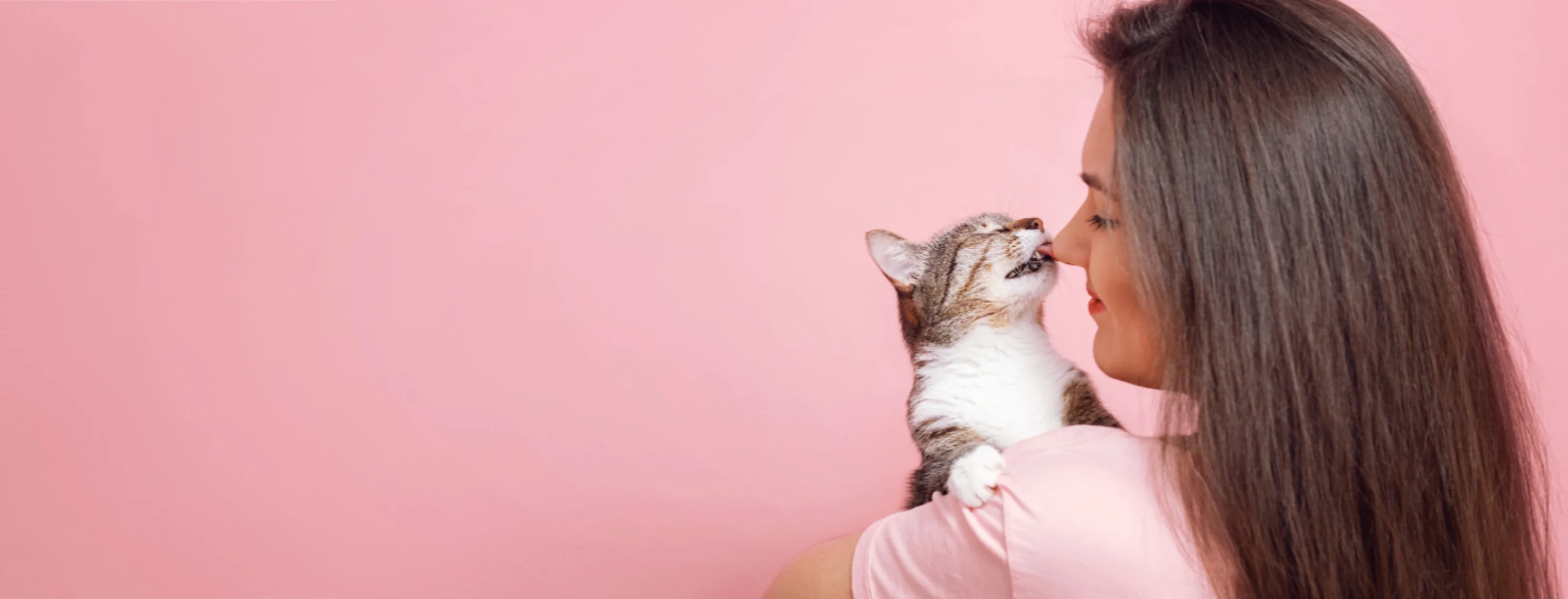 Kitten Licking a Woman's Nose