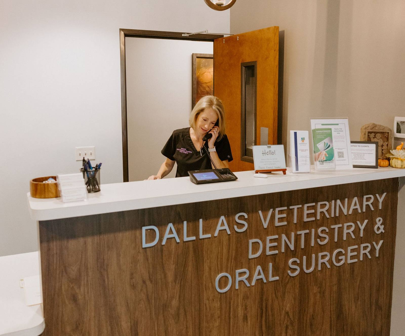 Staff taking a call at the receptionist desk.