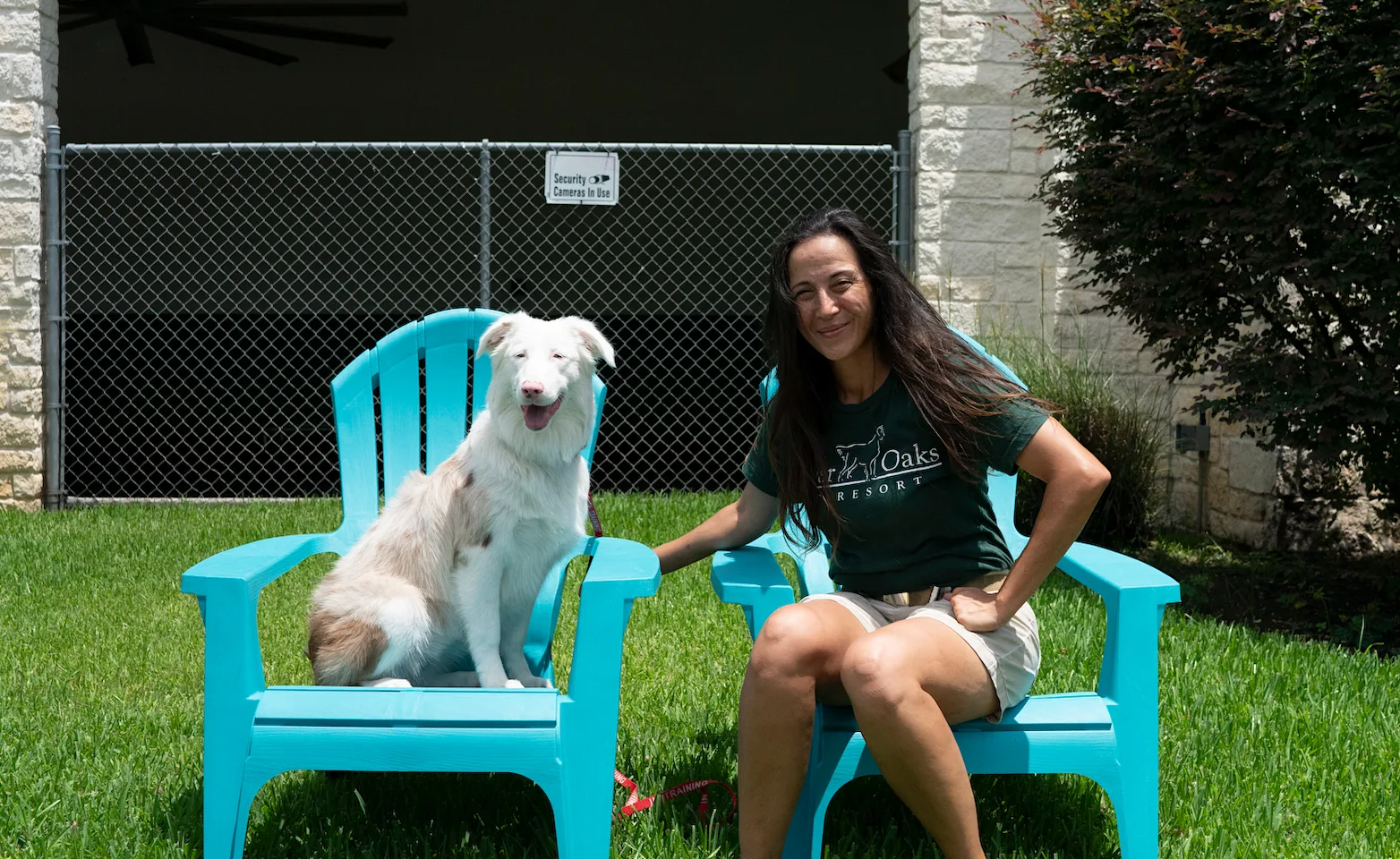 Staff sitting with dog at Rover Oaks Pet Reosrt