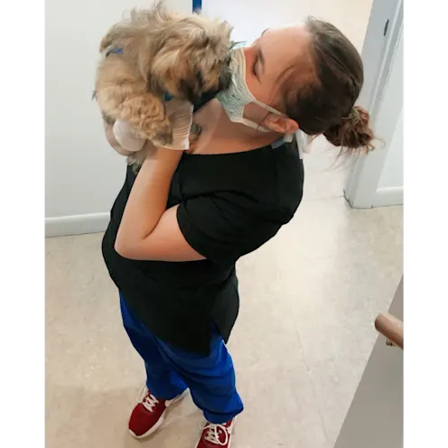 Staff Member Kissing a Dog Staff Member Kissing a Dog