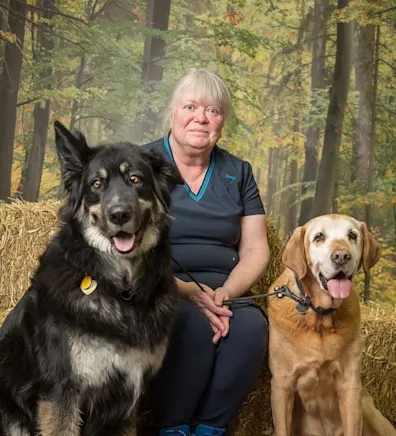 Evonne sitting with two dogs Evonne sitting with two dogs