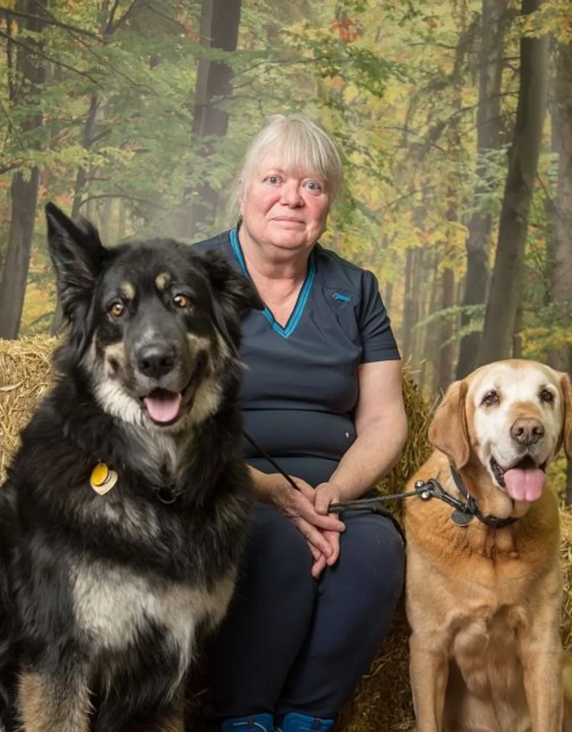 Evonne sitting with two dogs Evonne sitting with two dogs
