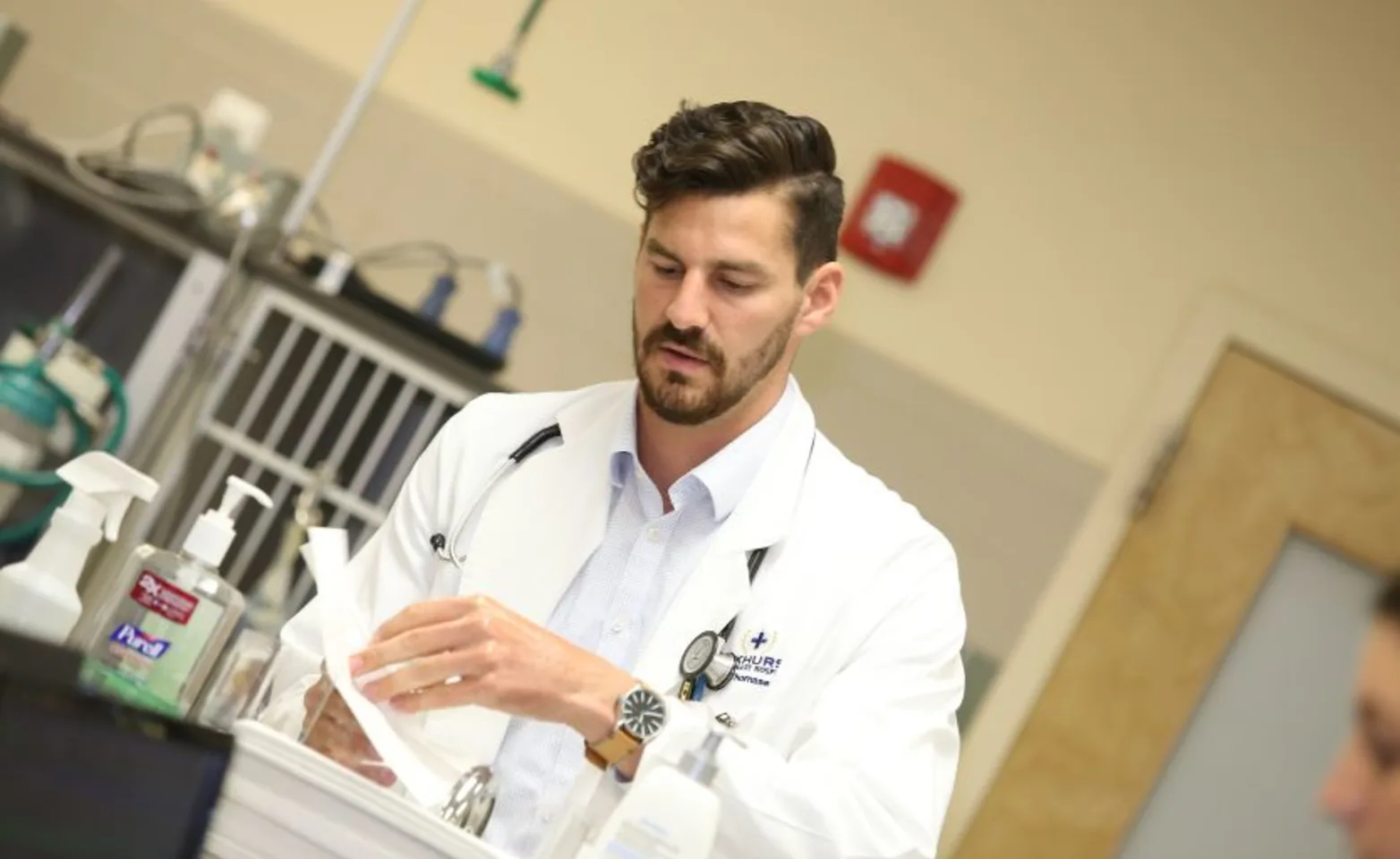 Photo of doctor prepping a station Photo of doctor prepping a station