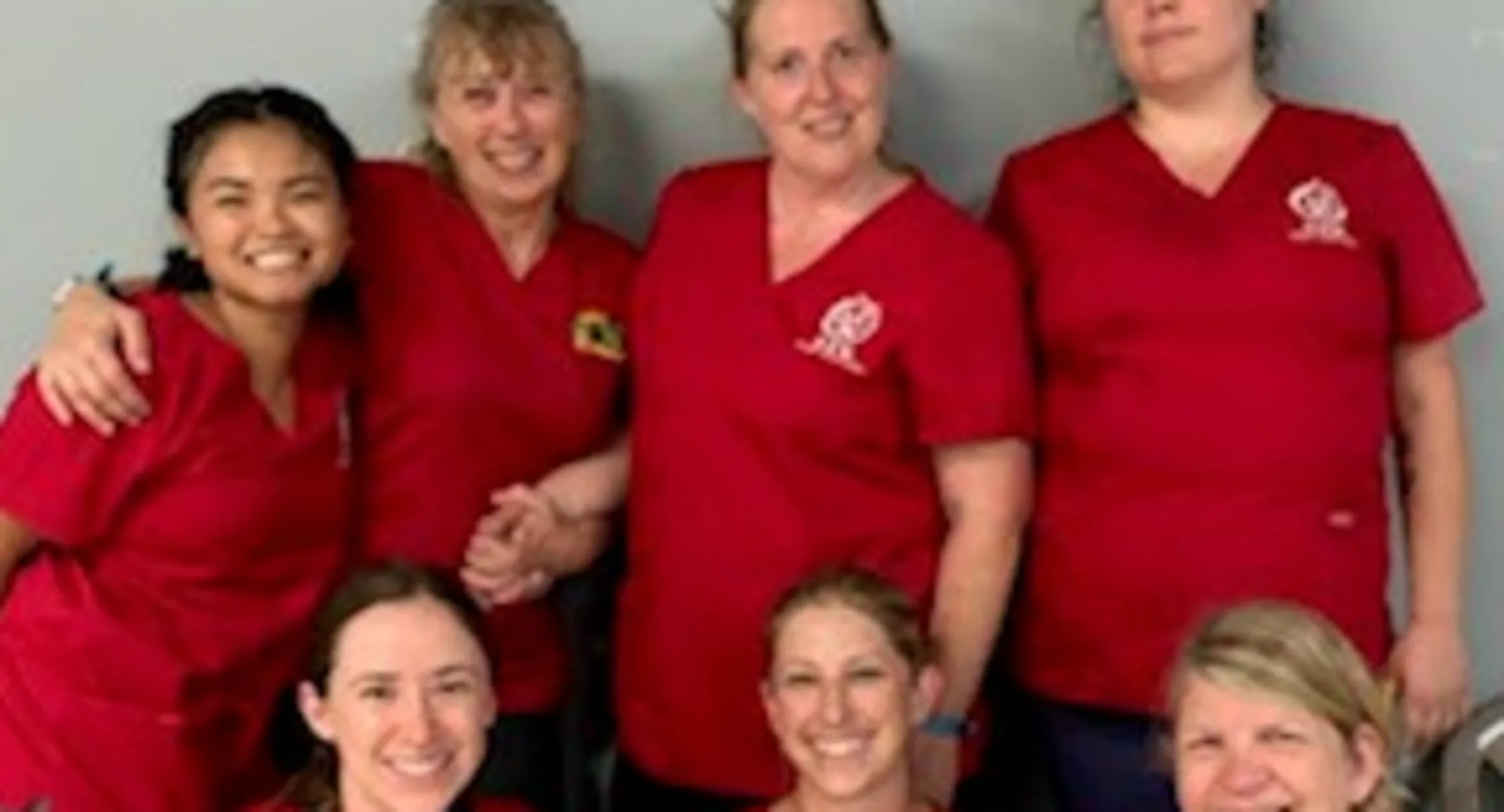 a group of Allandale's staff wearing red at Roatan Honduras a group of Allandale's staff wearing red at Roatan Honduras