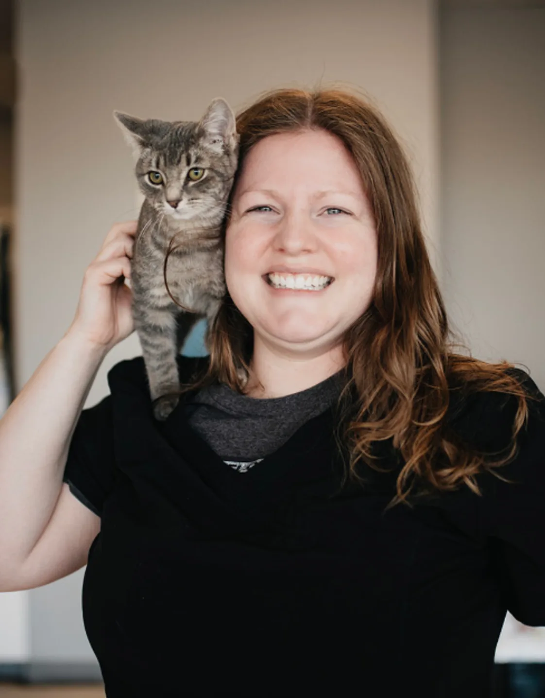 Alissa Wakeley dressed in black with a gray kitten on her shoulder Alissa Wakeley dressed in black with a gray kitten on her shoulder