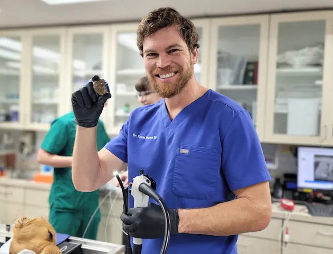 Dr. Shuman smiling while holding veterinary technology. Dr. Shuman smiling while holding veterinary technology.
