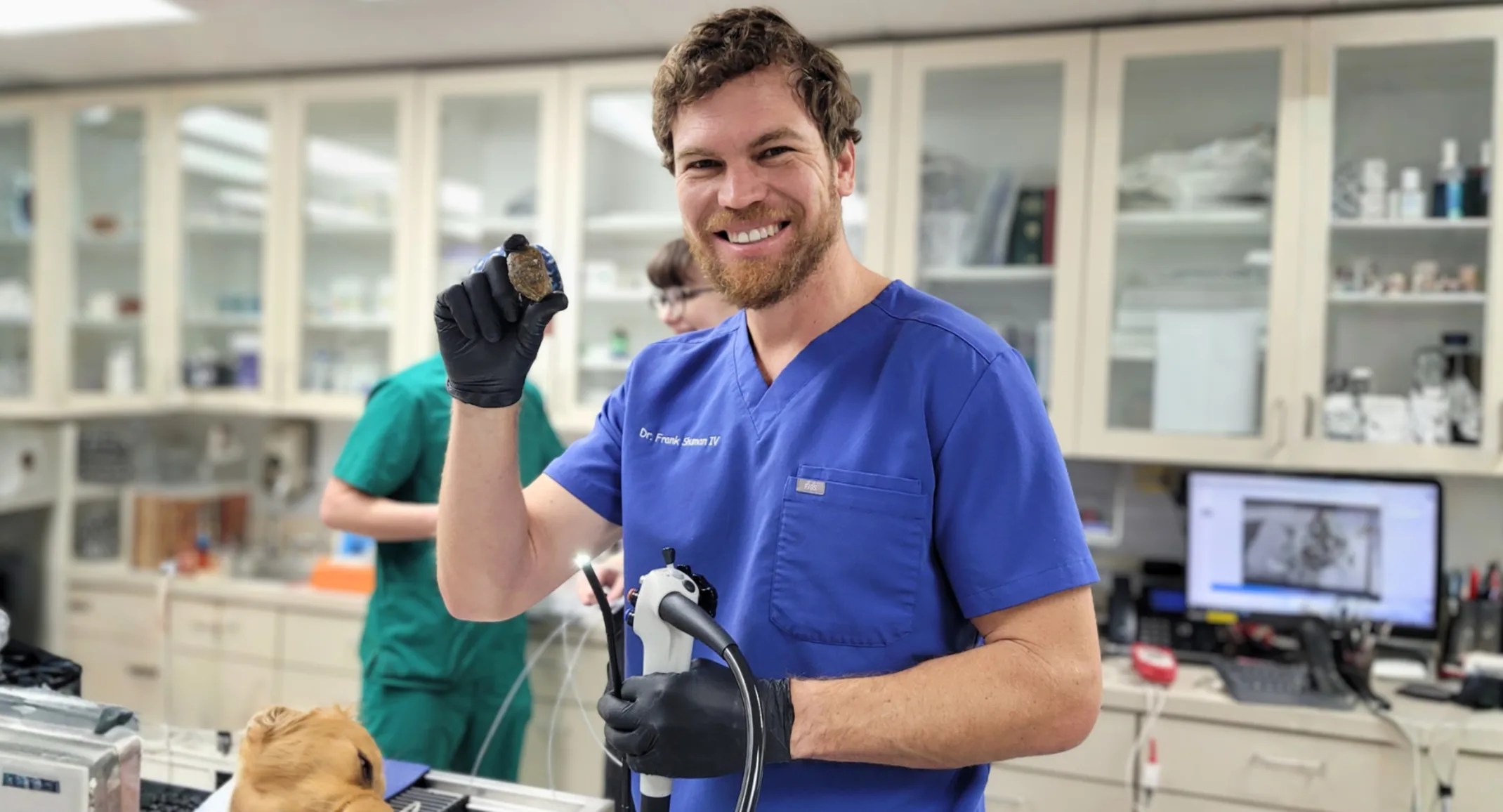 Dr. Shuman smiling while holding veterinary technology. Dr. Shuman smiling while holding veterinary technology.