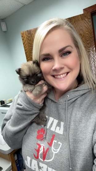  Staff Member Smiling with Puppy