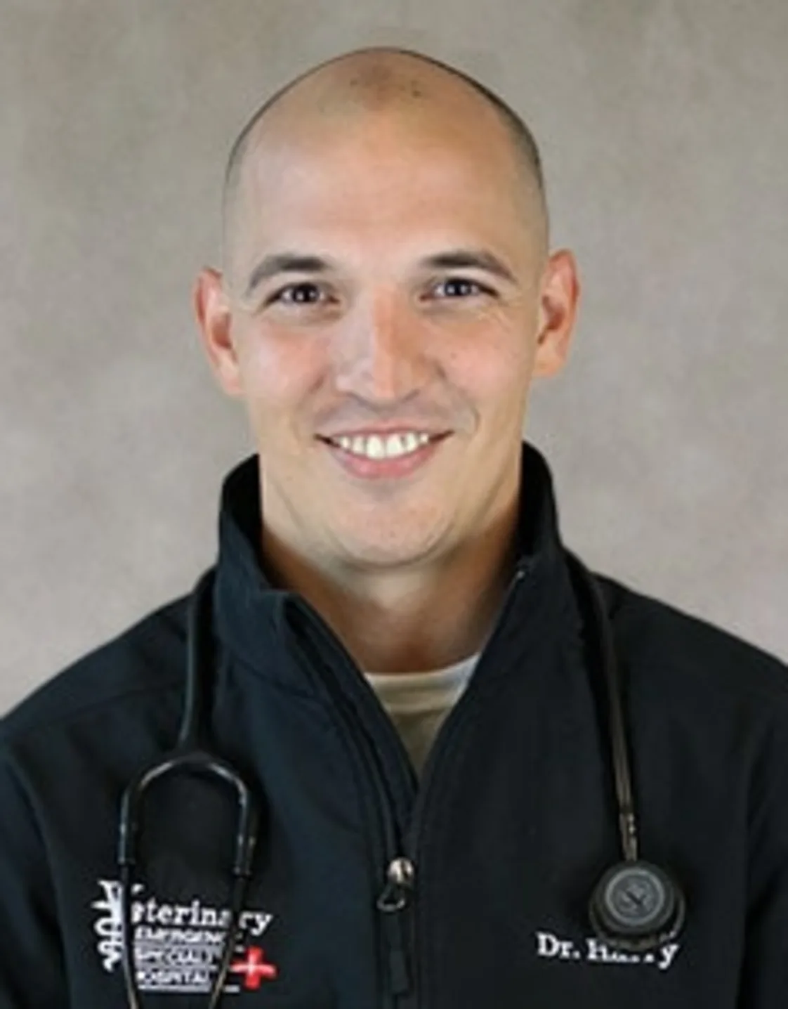 Dr. Jonah Harry smiling in front of a grey backdrop Dr. Jonah Harry smiling in front of a grey backdrop