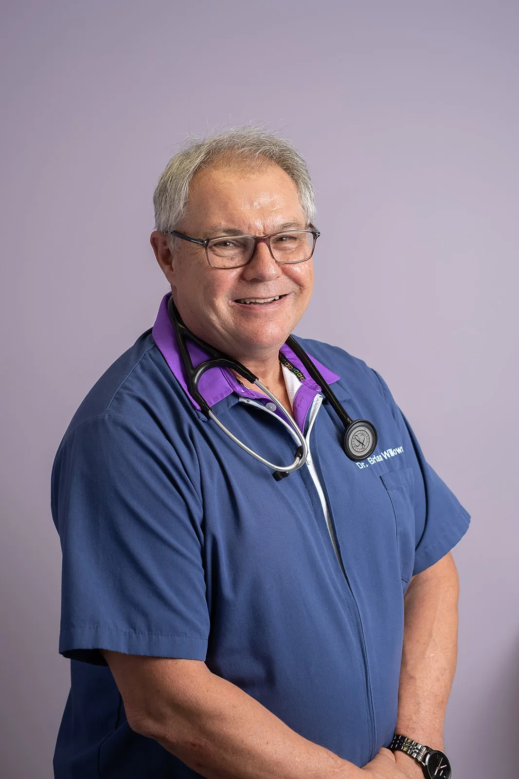 Dr. Brian Willows in front of a purple wall