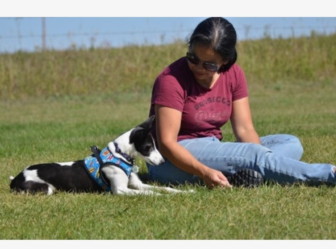 Tam training outdoors with dog