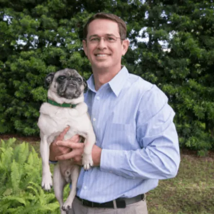 Daryl Haydel holding a small dog