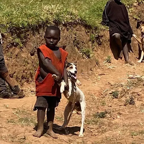 2 kids standing outside next to dogs 2 kids standing outside next to dogs