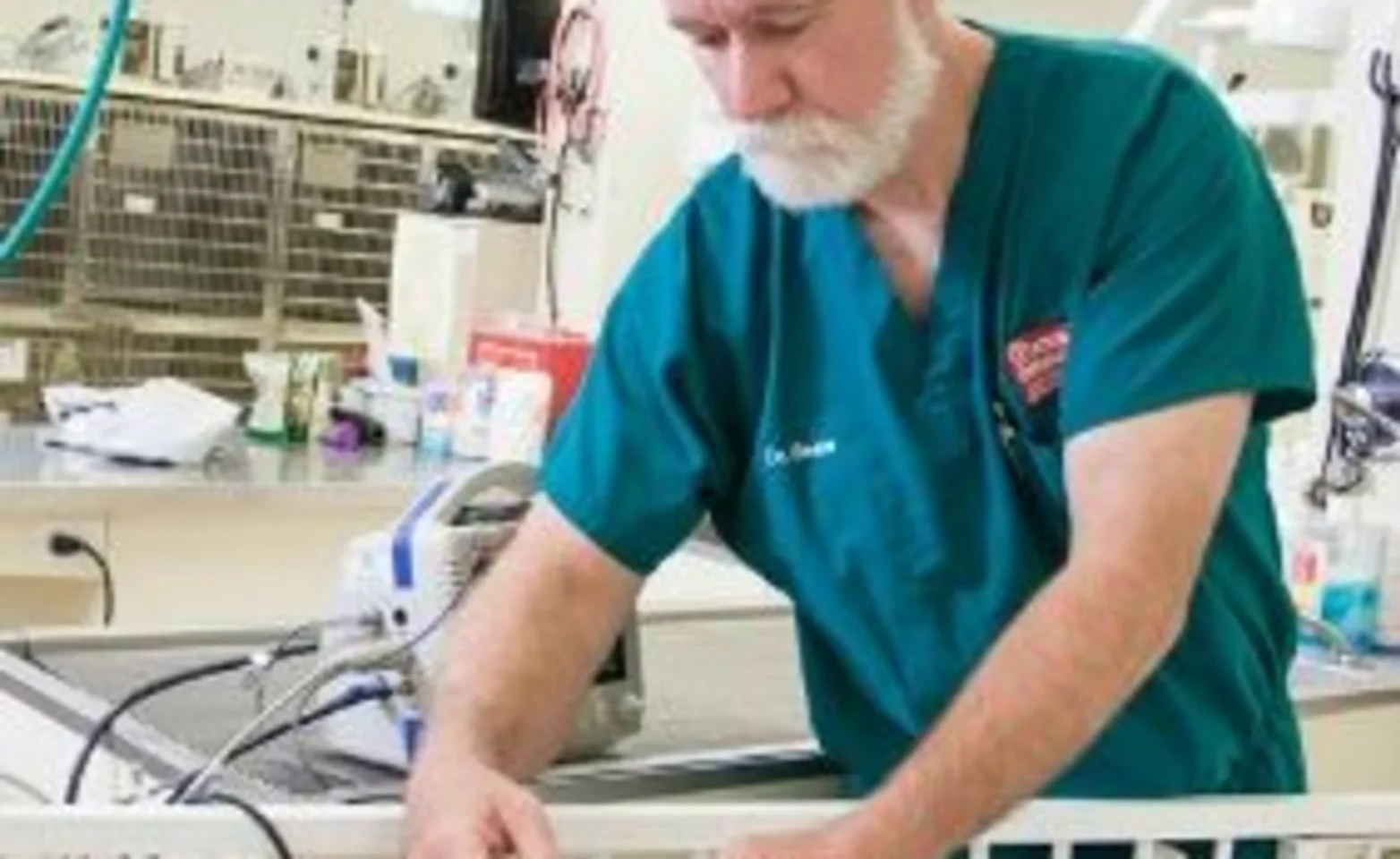 Dr. Beale tends to a patient in an ICU crib. Dr. Beale tends to a patient in an ICU crib.