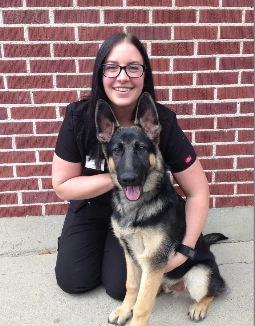 Megan Thompson knealing next to german shepherd