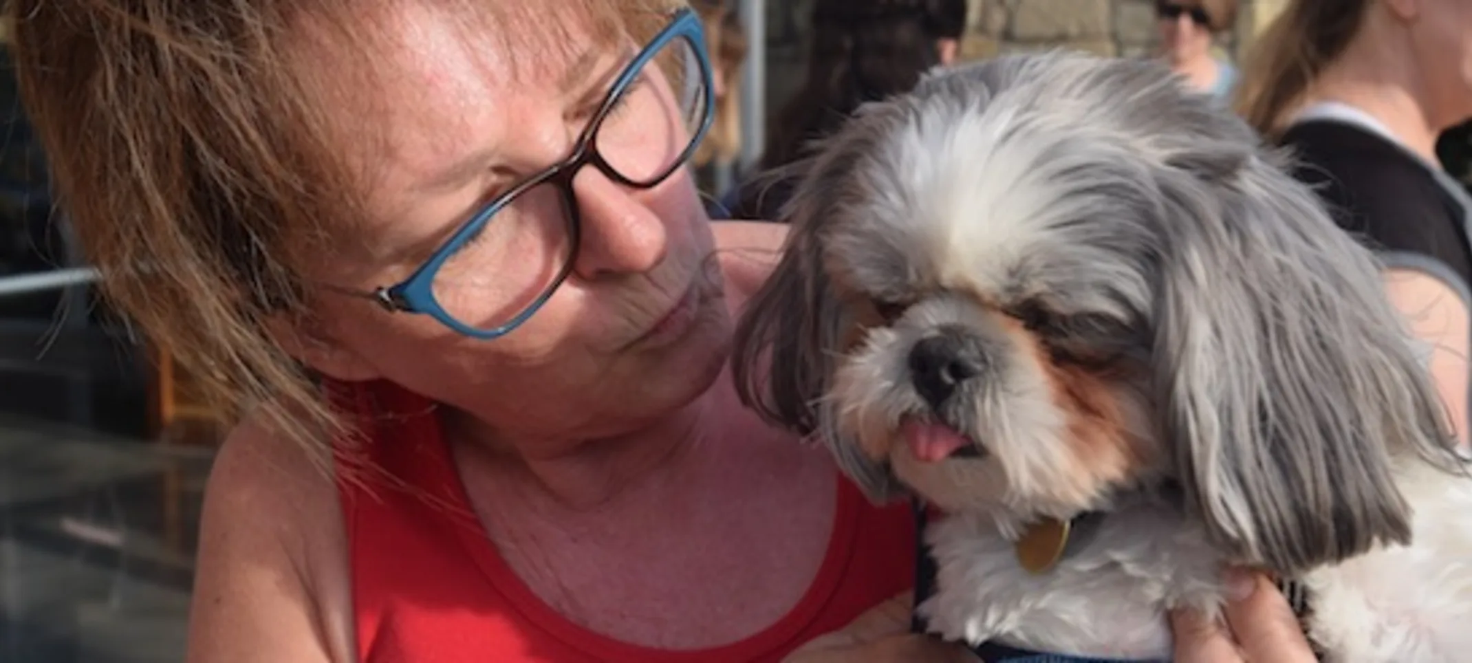 Lady holding dog with tongue out