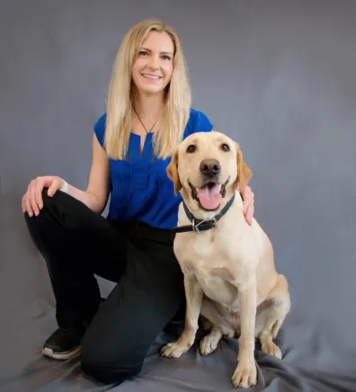 Dr. Katie Chiles sitting with a dog
