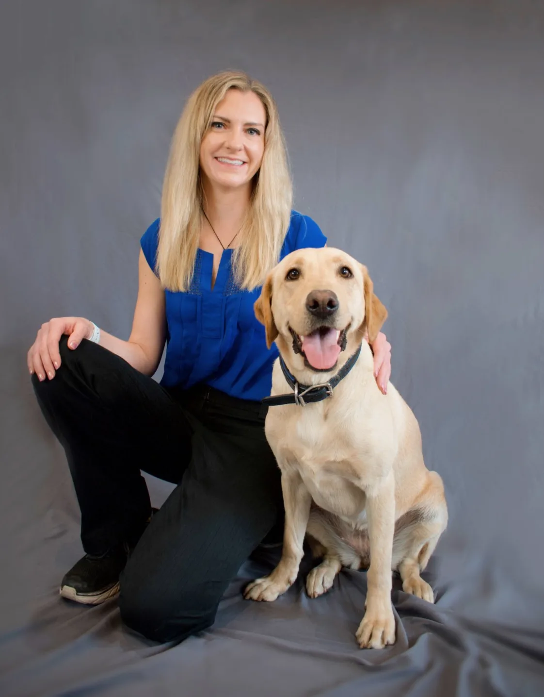 Dr. Katie Chiles sitting with a dog Dr. Katie Chiles sitting with a dog