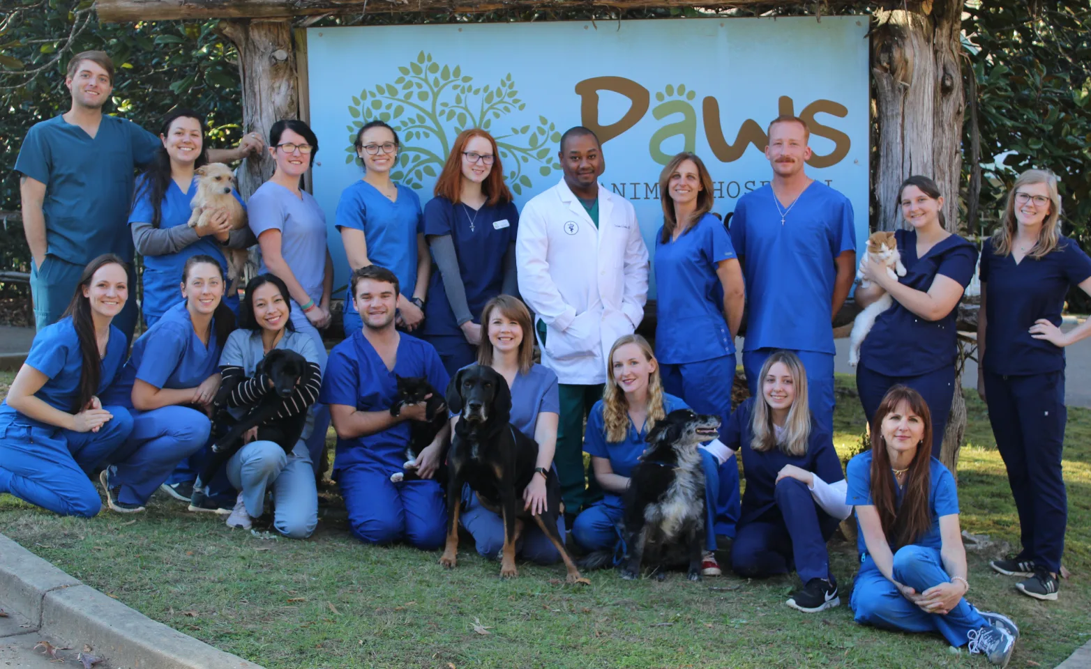 Pampered Paws Animal Hospital Group Staff Photo posing in front of the front sign