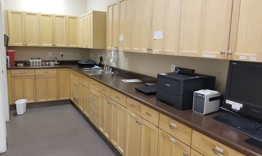 Large laboratory area with lots of storage cabinets at Central Coast Pet Emergency Clinic