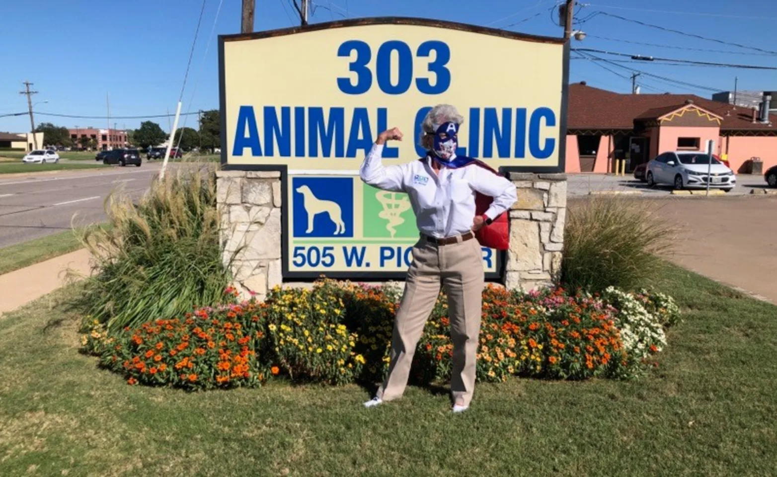 Dr. Wicker in front of 303 Animal Clinic Sign