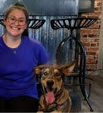 Bianca holding a black cat and sitting in a chair at Grandview Veterinary Clinic Bianca holding a black cat and sitting in a chair at Grandview Veterinary Clinic