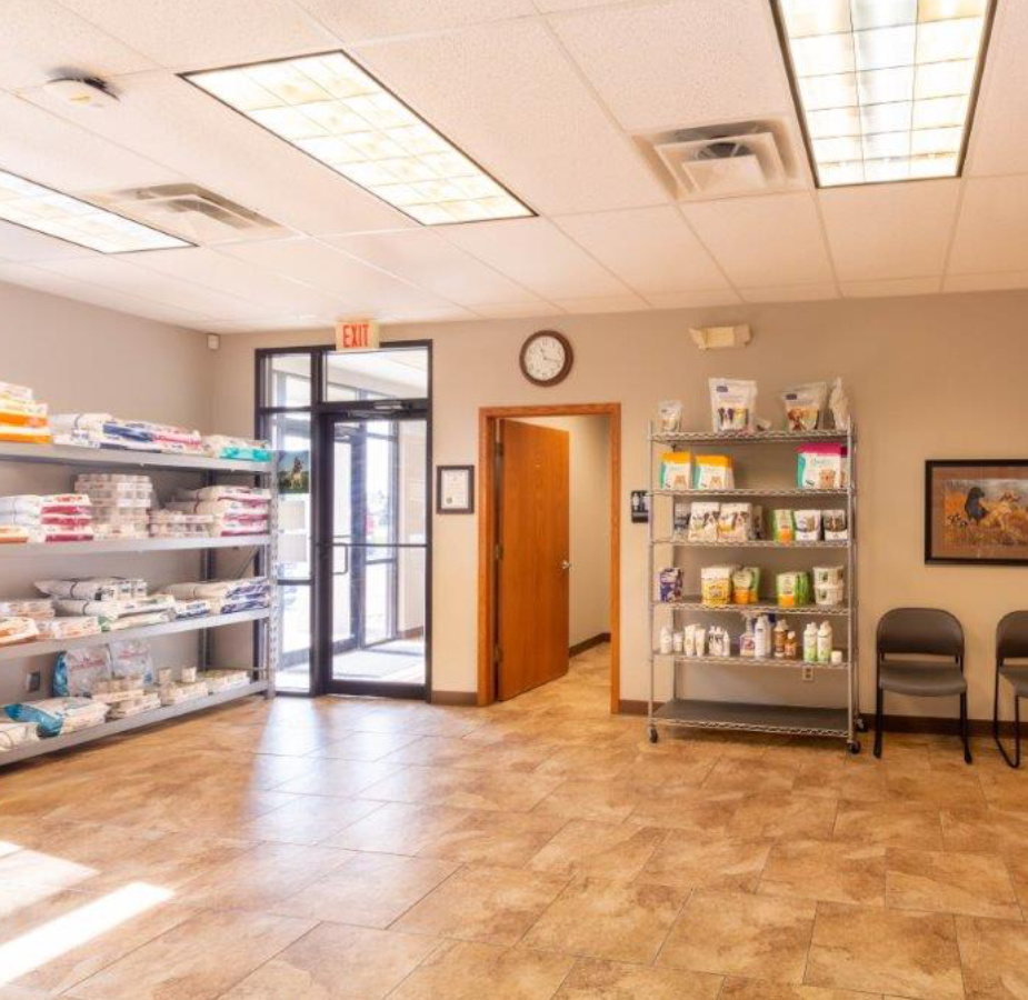A photo of The welcoming lobby and waiting area at Dunes Animal Hospital, which has shelves stocked with animal food.