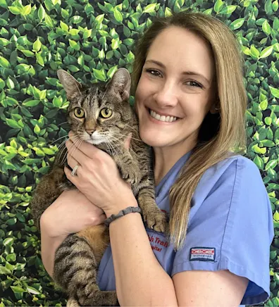 Lindsay C.'s staff photo from Spanish Trail Animal Hospital where she is outside in the front yard holding a fluffy brown dog in her arms. Lindsay C.'s staff photo from Spanish Trail Animal Hospital where she is outside in the front yard holding a fluffy brown dog in her arms.