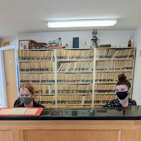 Two staff members working at the front desk at Henniker Veterinary Hospital Two staff members working at the front desk at Henniker Veterinary Hospital